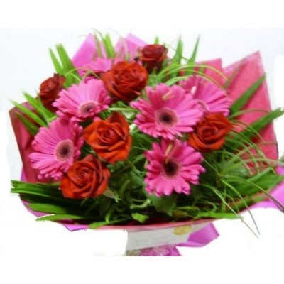 A vibrant mix of gerberas and roses presented in a bouquet